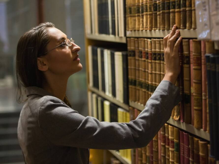 Lawyer picking book in the law library at the university